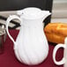 A white Choice thermal coffee carafe on a table.