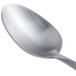 An Arcoroc stainless steel demitasse spoon with a silver handle.