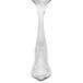 A Libbey stainless steel bouillon spoon with a design on the handle.