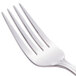 A close-up of a Libbey stainless steel dessert fork with four forks on it.