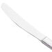 A Libbey stainless steel entree knife with a fluted blade and white handle.