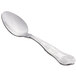 A Libbey stainless steel demitasse spoon with a design on the handle.