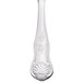 A Libbey stainless steel dessert spoon with a decorative design on the handle.