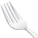 A close-up of a Libbey stainless steel salad fork with a white handle.