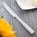 A Libbey stainless steel bread and butter knife on a table.