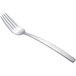 An Arcoroc stainless steel salad fork with a silver handle on a white background.