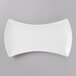 A Schonwald white porcelain bowtie tray with a curved edge.