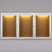 A row of three white Aarco lighted bulletin board cabinets.