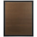A brown rectangular Aarco bulletin board with a black frame.