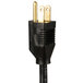 A black electrical plug with gold tips on a black and gold power cord.