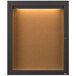 A brown bronze anodized Aarco bulletin board cabinet with a light inside.