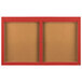Two brown rectangular bulletin boards with red frames and doors.