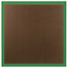 An Aarco brown bulletin board with a green frame.