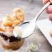 A Chef & Sommelier stainless steel dessert spoon holding a spoonful of whipped cream.