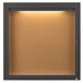 A brown cork board with a light inside.