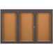 A brown rectangular cabinet with a black metal border and three glass doors.