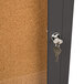 A bronze Aarco bulletin board cabinet with a key lock on a door.