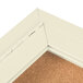 A white Aarco indoor bulletin board with a cork interior and white door hinge.