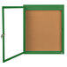 A green framed bulletin board with a door open.