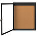 A black framed notice board with a glass door.