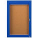 A blue Aarco indoor bulletin board cabinet with a glass door and key.
