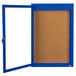 A blue framed enclosed bulletin board with a glass door.
