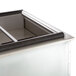 A Delfield drop-in refrigerated cold food well with a stainless steel lid on a counter.