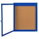 A blue framed bulletin board with a blue door.