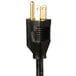 A black electrical plug with a gold tip on a black and gold power cord.