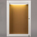 A white framed cabinet door with a light inside.