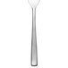 An Arcoroc stainless steel oyster fork with a white handle.