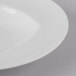 A Schonwald Continental White Rim Deep Porcelain Bowl on a white surface.