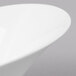 A close up of a Schonwald white porcelain bowl with a curved edge.