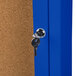 An Aarco blue indoor bulletin board cabinet with a key in the lock.