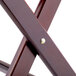 A close up of a Lancaster Table & Seating mahogany wood cross.