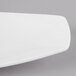 A close-up of a Schonwald white porcelain long tray with a curved edge.