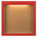 A red framed enclosed bulletin board with a light.
