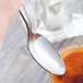 A close-up of a Libbey stainless steel teaspoon.
