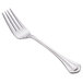 A close-up of a World Tableware Resplendence silver salad fork with a white handle.