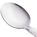 A Libbey 18/0 stainless steel iced tea spoon with a white handle and silver spoon.