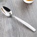 A Libbey stainless steel dessert spoon on a table.