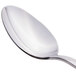 A close-up of a Libbey stainless steel dessert spoon with a silver handle.