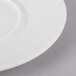A close up of a Schonwald white porcelain saucer with a white rim.