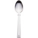 A silver dessert spoon with a white handle.