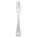A silver Libbey cocktail fork with a white background.