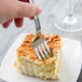 A Libbey stainless steel dessert fork in a piece of cake.