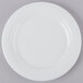 A Schonwald Avanti Gusto white porcelain plate on a gray surface.