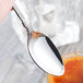 A Libbey stainless steel teaspoon with a spoon of something on it.