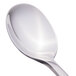 A close-up of a Libbey stainless steel demitasse spoon with a silver handle.