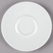 A close-up of a Schonwald white porcelain saucer with a small rim.
